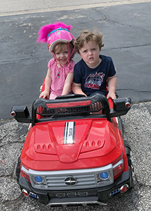 Kelsey and Lachlan in their Power Wheels - Thumbnail
